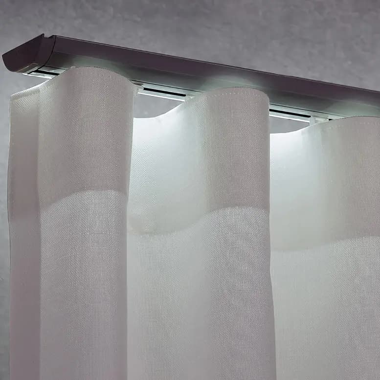 Black design curtain track installed against a dark ceiling