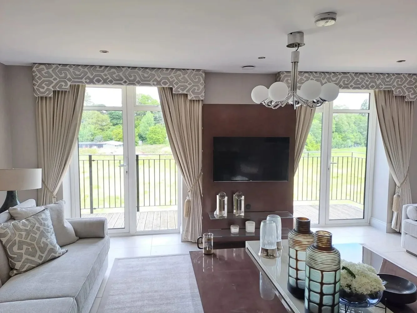 Dual twin pleated curtains with tie backs onto balcony
