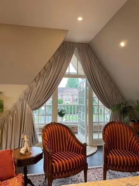 Show home Bespoke curtains fitted into Apex leading to balcony